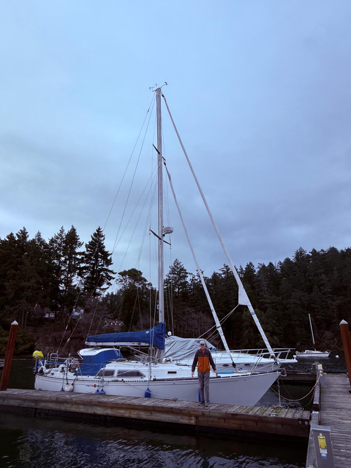 A man standing on the dock beside Petronella